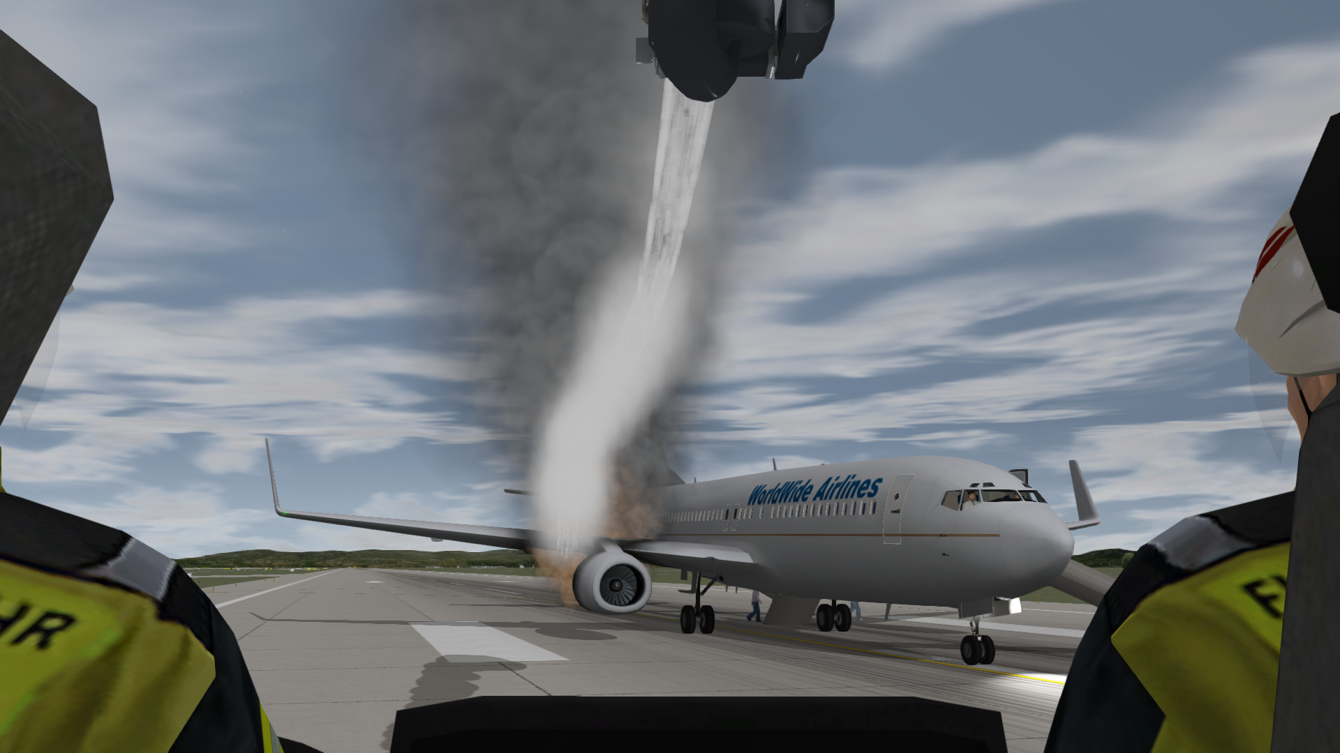 Inside the cabin of an ARFF Truck fighting an aircraft engine fire while passengers evacuate as a training exercise in ADMS.